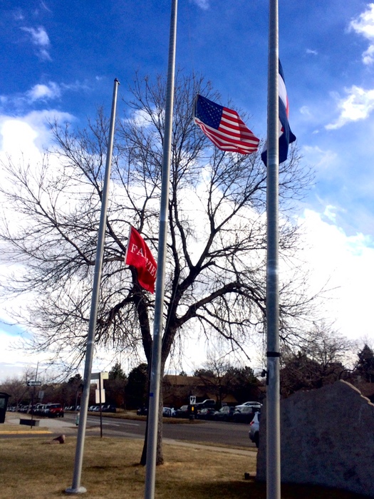 The US flag at half mast outside the school.